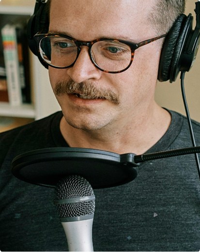 Portrait of the marketer persona, recording at a microphone.